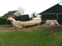 a wooden boat carved out of a tree stump