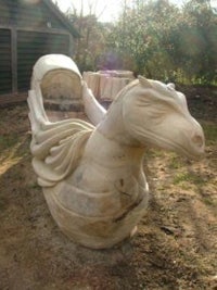 a statue of a horse in a yard
