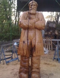 a wooden statue of a man with a beard