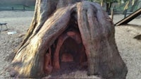 a tree house made out of a tree stump