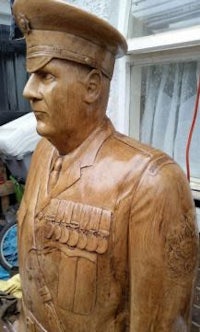 a wooden statue of a man in uniform