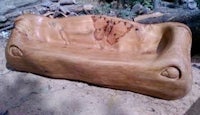 a wooden couch made out of logs