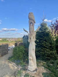 a statue of an owl in a garden