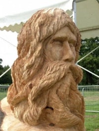 a wood carving of a man with a beard