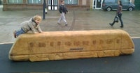 a child is standing on top of a large wooden train