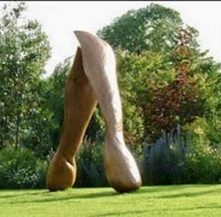 a large wooden sculpture in a garden
