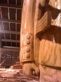 a wooden statue of a soldier in a museum