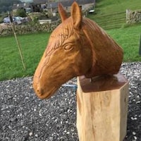 a wood carving of a horse head