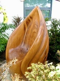 a wooden chair in front of a building