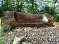 a bench made out of a tree trunk