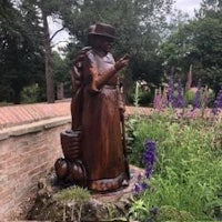 a statue of a woman in a garden