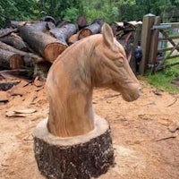 a horse head carved out of a tree stump