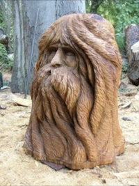 a wood carving of a man with a beard