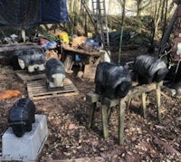 a group of sheep statues in a wooded area
