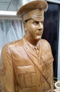 a wooden statue of a man in uniform